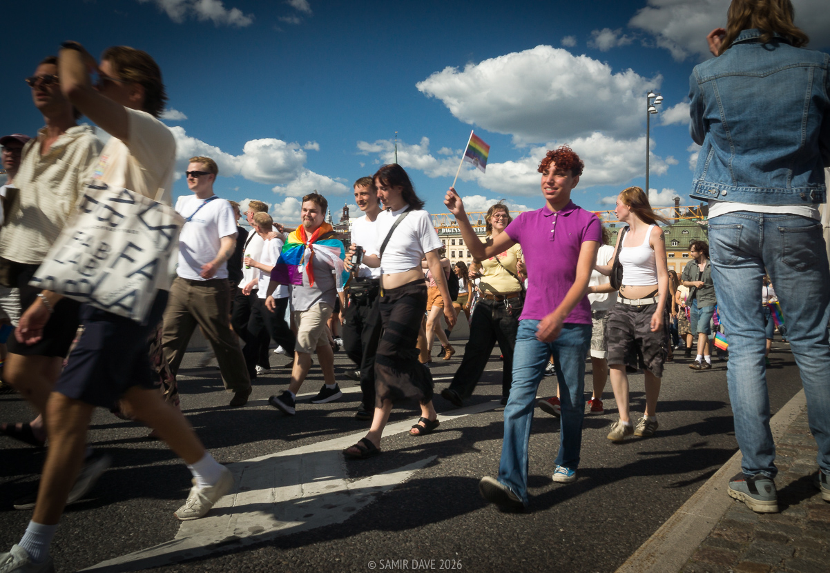 Young man with pride flag Södermalmstrand, Slussen, Stockholm.