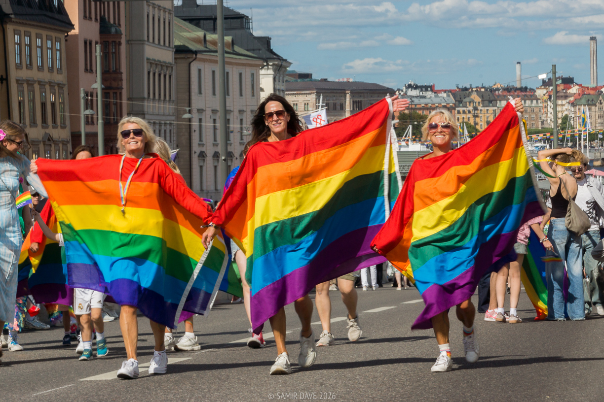 Women carrying pride flags, Södermalsmstrand, Slussen.