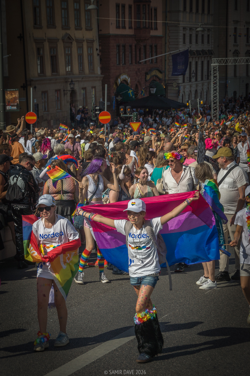 Walking with the bisexual pride flag, Slussbron, Stockholm Pride Festival 2026.