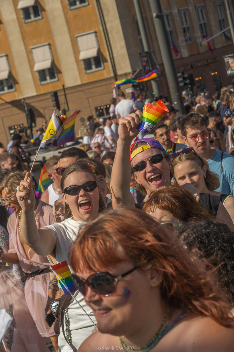 People filled with joy as they wave flags proudly at Stockholm Pride Festival 2026.
